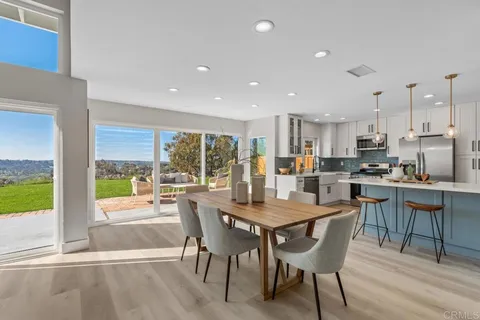 a kitchen with stainless steel appliances white cabinets and a stove top oven