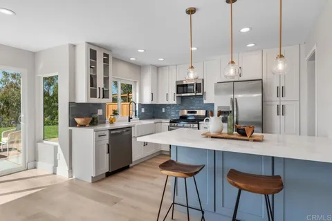 a kitchen with counter top space cabinets and appliances