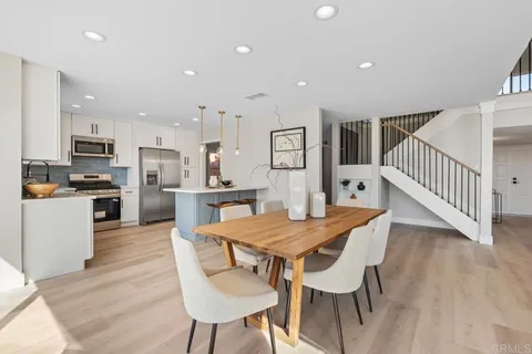 a view of a hallway with living room and dining room