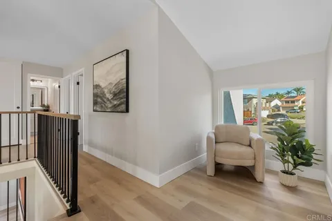 a bedroom with a large bed and paintings on the wall