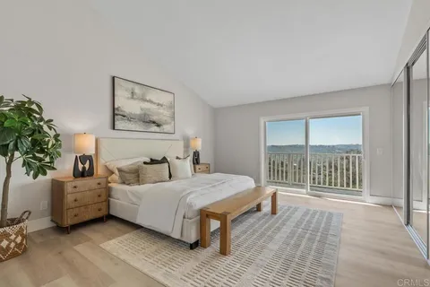 a bedroom with a large bed and a large window