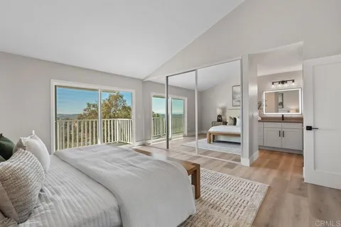 a en suite bathroom with a granite countertop sink and a mirror