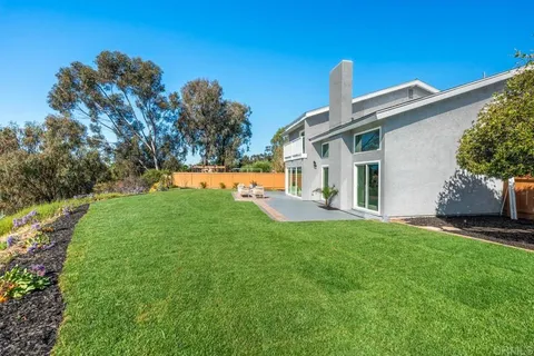 a view of a brick house with a yard