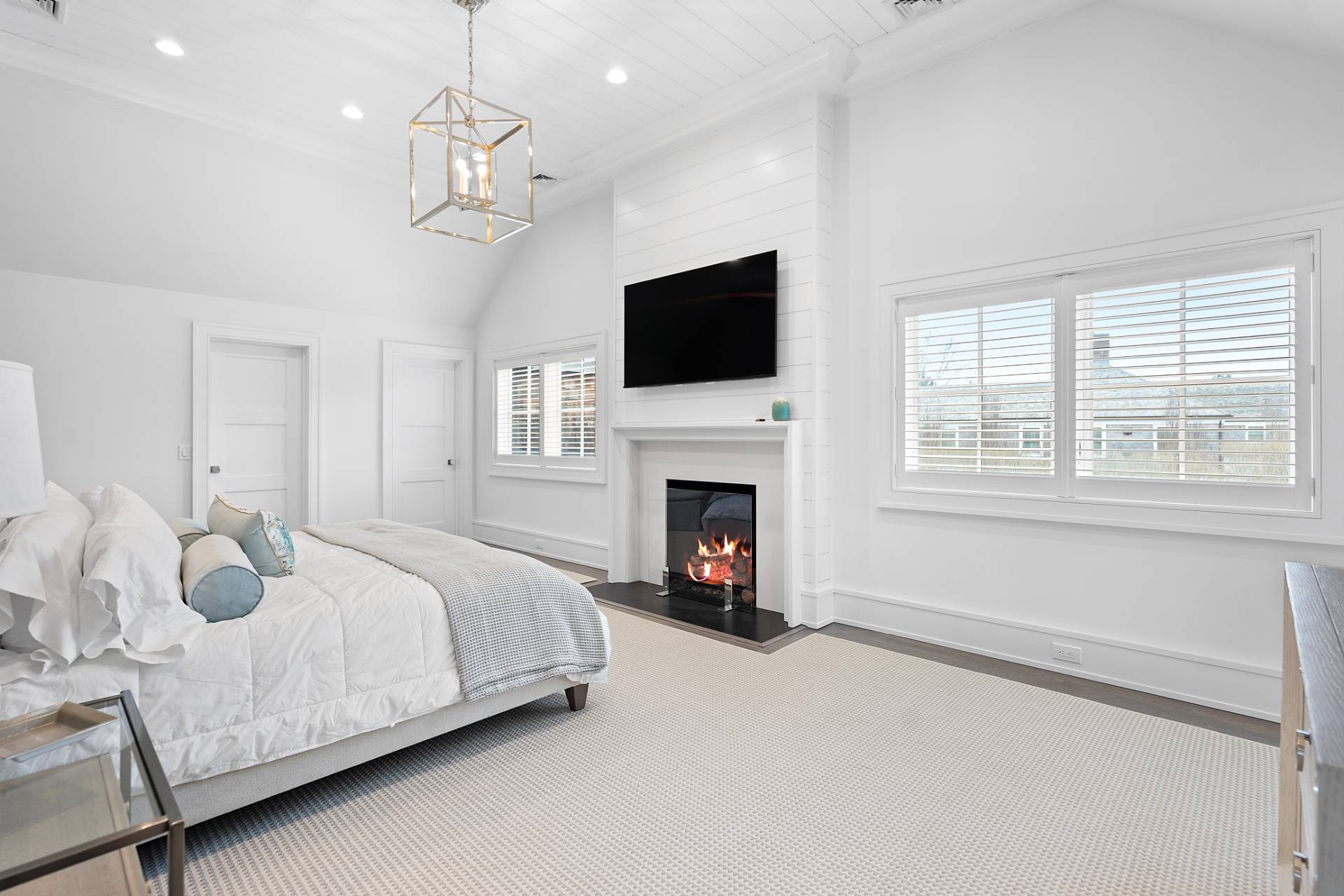 135 Hildreth Lane Bridgehampton, NY 11932 - Photo 16 of 38 a bedroom with a large bed and a flat screen tv