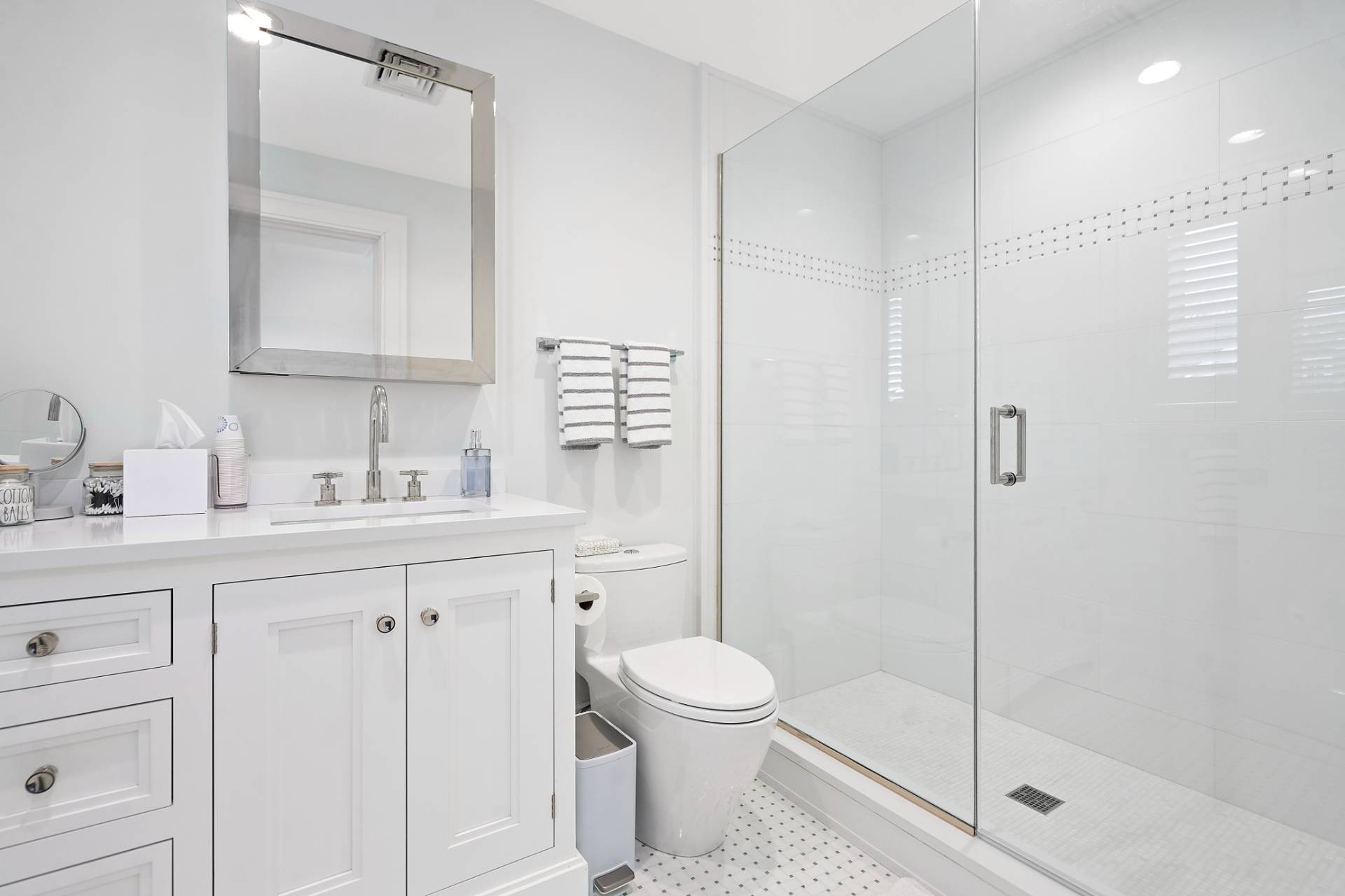 135 Hildreth Lane Bridgehampton, NY 11932 - Photo 26 of 38 a bathroom with a toilet a sink a glass door a shower and a mirror