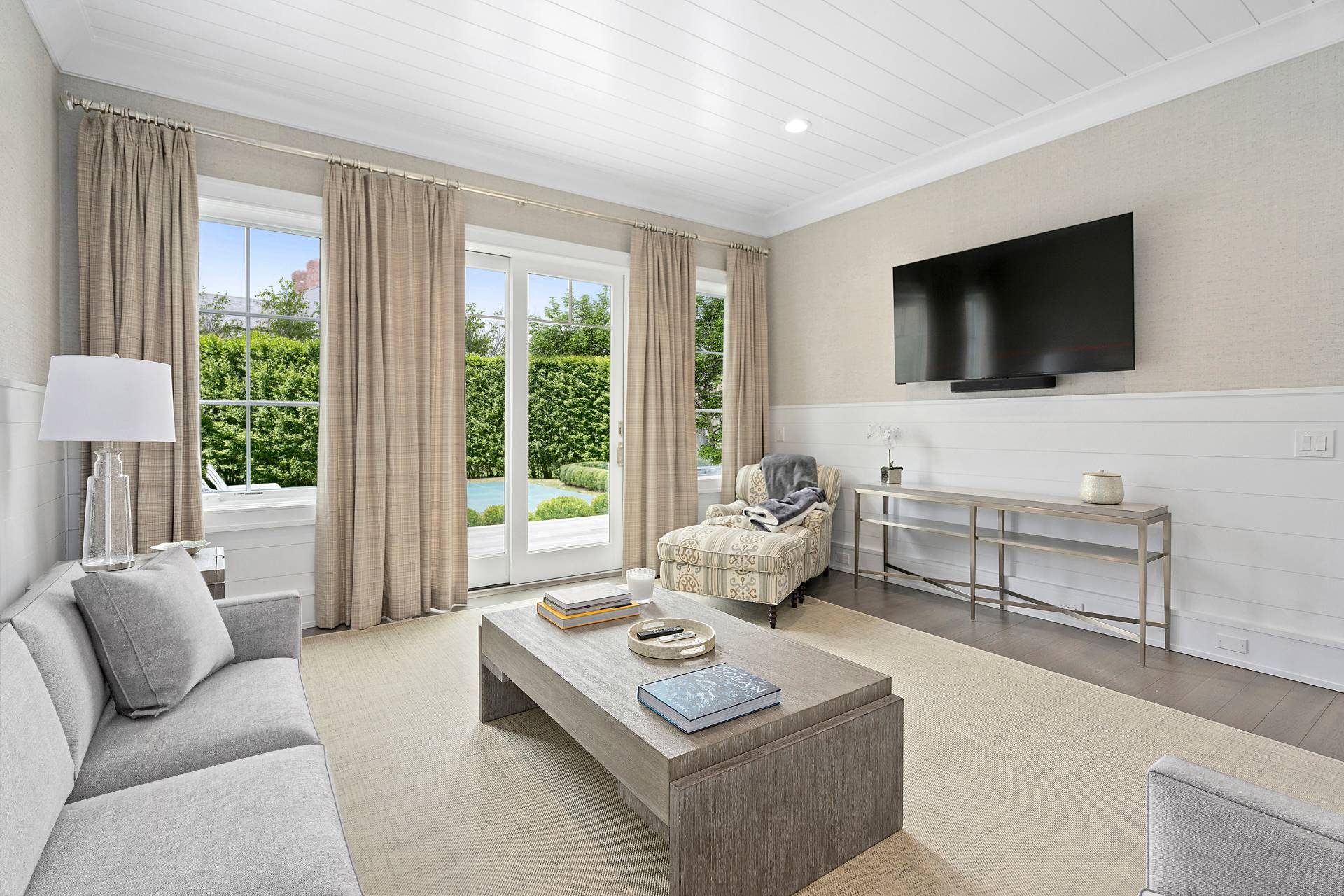 135 Hildreth Lane Bridgehampton, NY 11932 - Photo 30 of 38 a living room with furniture a flat screen tv and a large window