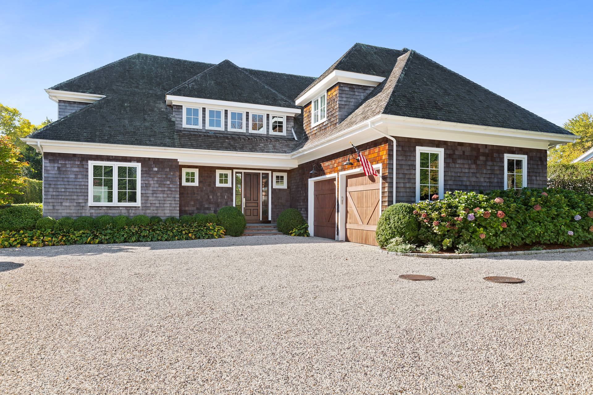 135 Hildreth Lane Bridgehampton, NY 11932 - Photo 3 of 38 a front view of a house with a yard
