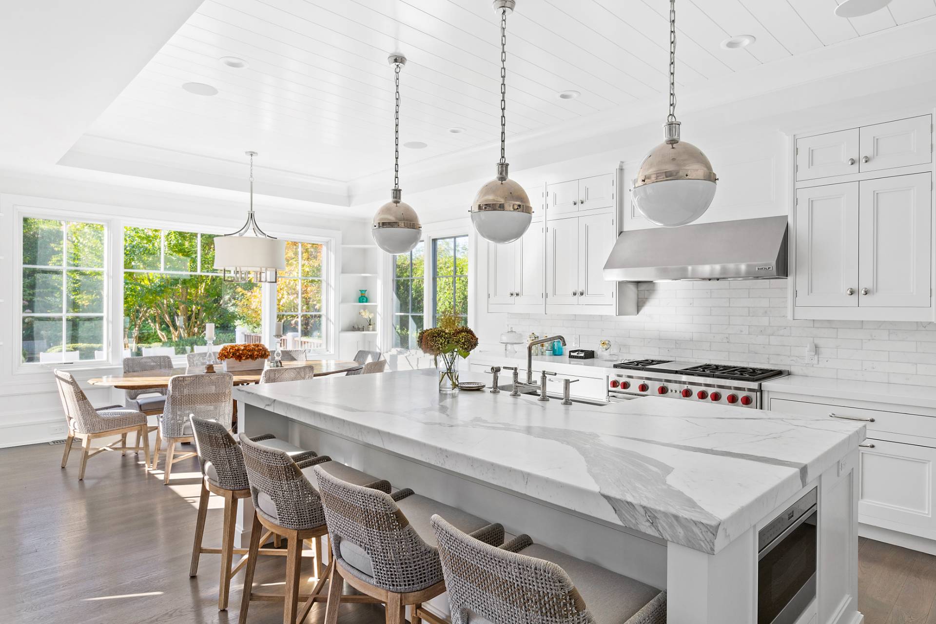 135 Hildreth Lane Bridgehampton, NY 11932 - Photo 9 of 38 a kitchen with stainless steel appliances granite countertop a stove a kitchen island a table and chairs in it