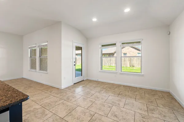 a view of a hallway with wooden cabinet and refrigerator