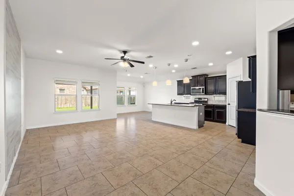 a view of kitchen with refrigerator and microwave
