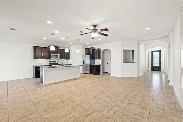 a large white kitchen with cabinets and stainless steel appliances