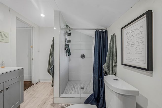 a bathroom with a shower toilet and sink