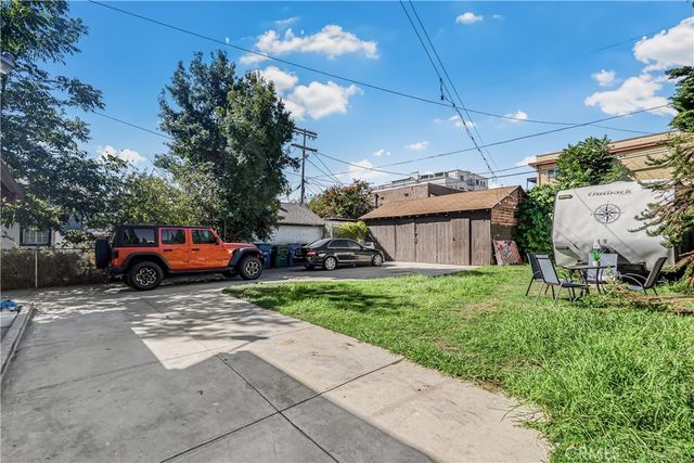a view of a house with truck parked on the side of the road