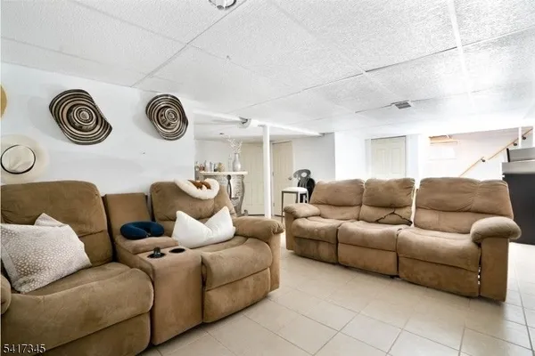 a living room with furniture and a mirror