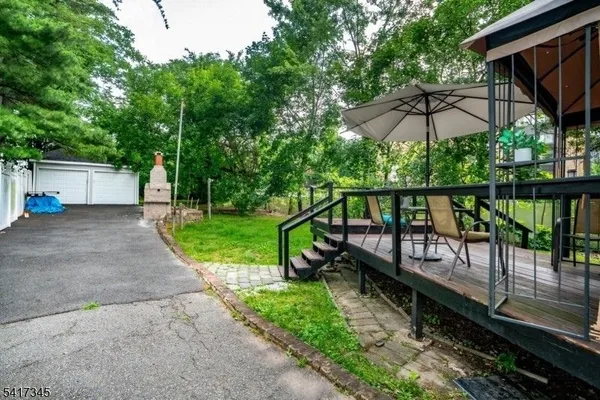 a view of a wooden deck with a yard