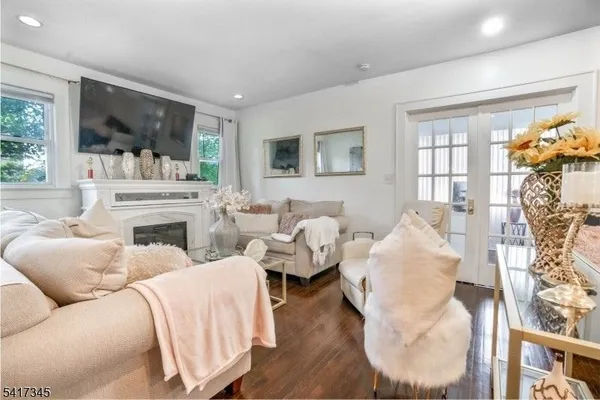 a living room with furniture fireplace and flat screen tv