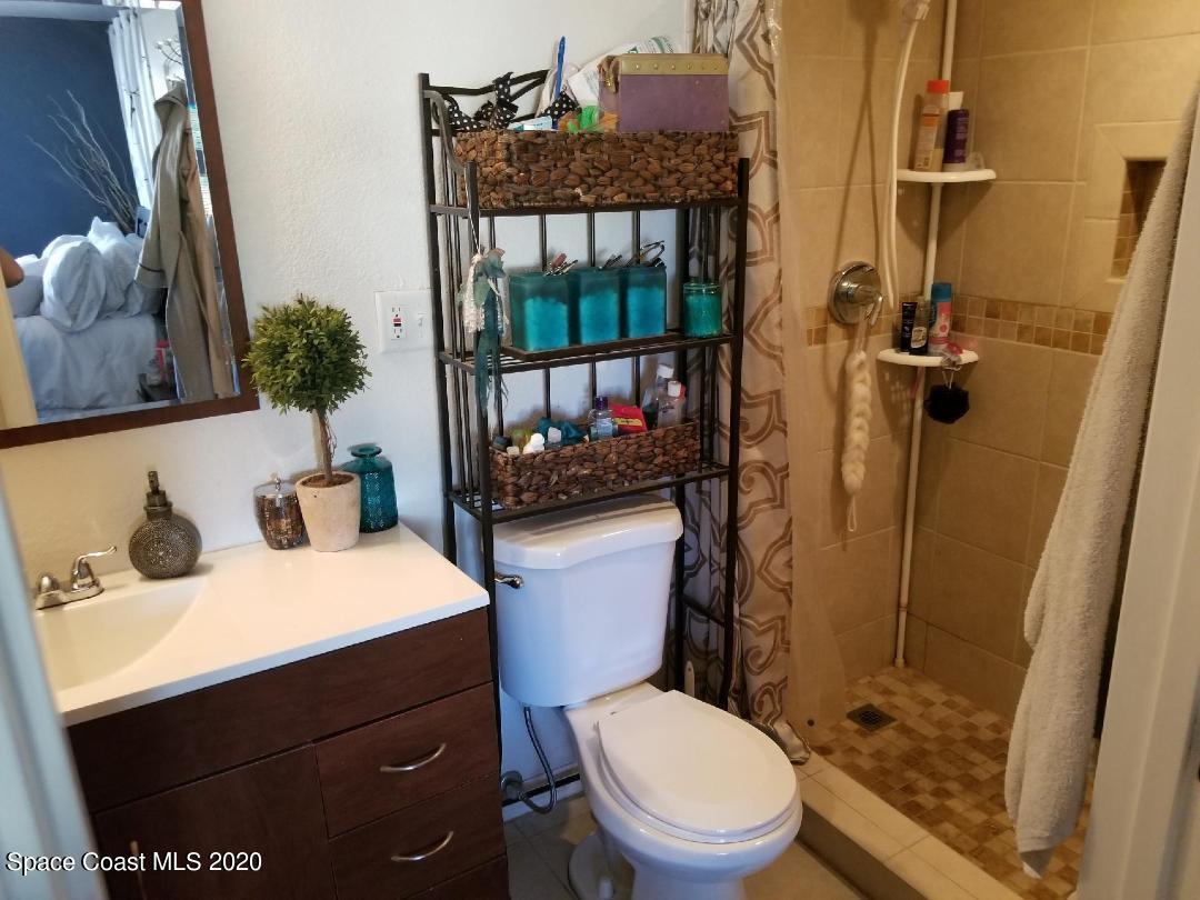2173 Fatzler Road Melbourne, FL 32935 - Photo 8 of 13 a bathroom with a sink a toilet and shower