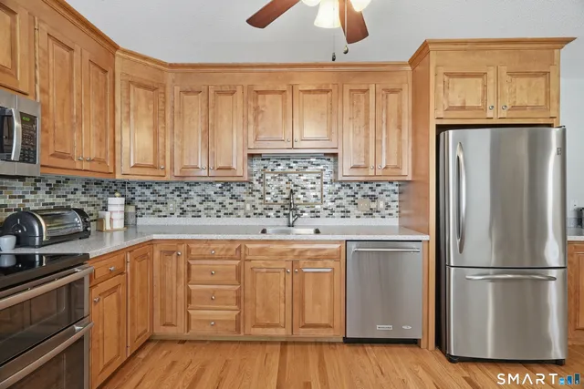 a view of a dining room with furniture a kitchen and chandelier