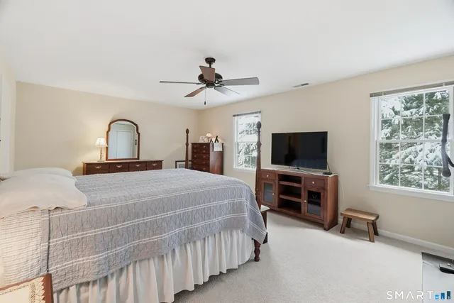 a spacious bedroom with a bed and a walk in closet