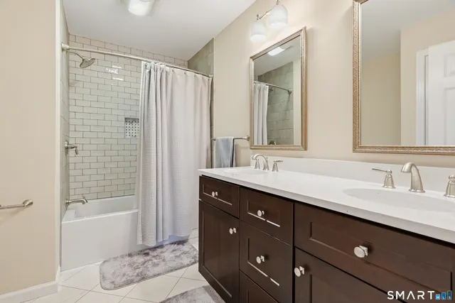 a bedroom with a bed table and a window