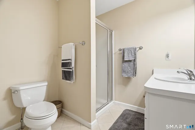 a view of a hallway with wooden floor and a livingroom