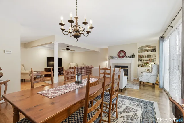 a view of a dining room with furniture a rug and wooden floor
