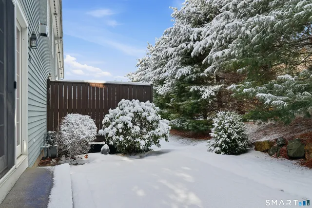 a view of a house with a tree and a yard