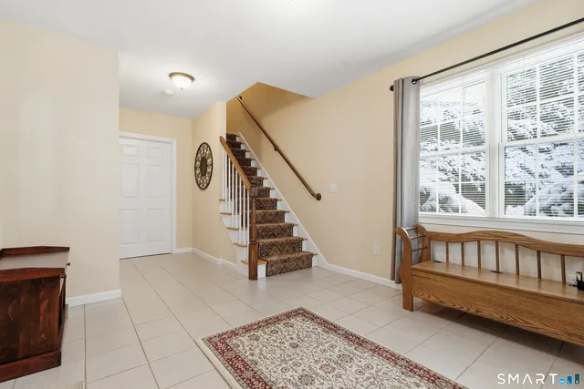 a bathroom with a tub shower and window