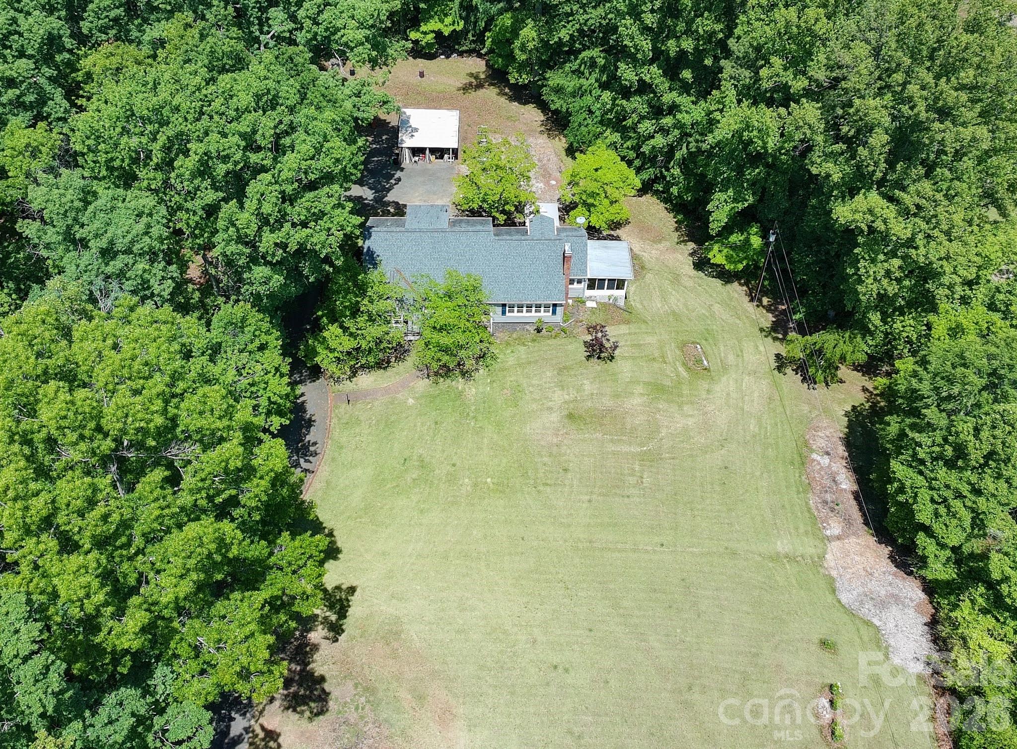 951 Dodson Mill Road Pilot Mountain, NC 27041 - Photo 44 of 48 an aerial view of residential house with outdoor space and trees all around