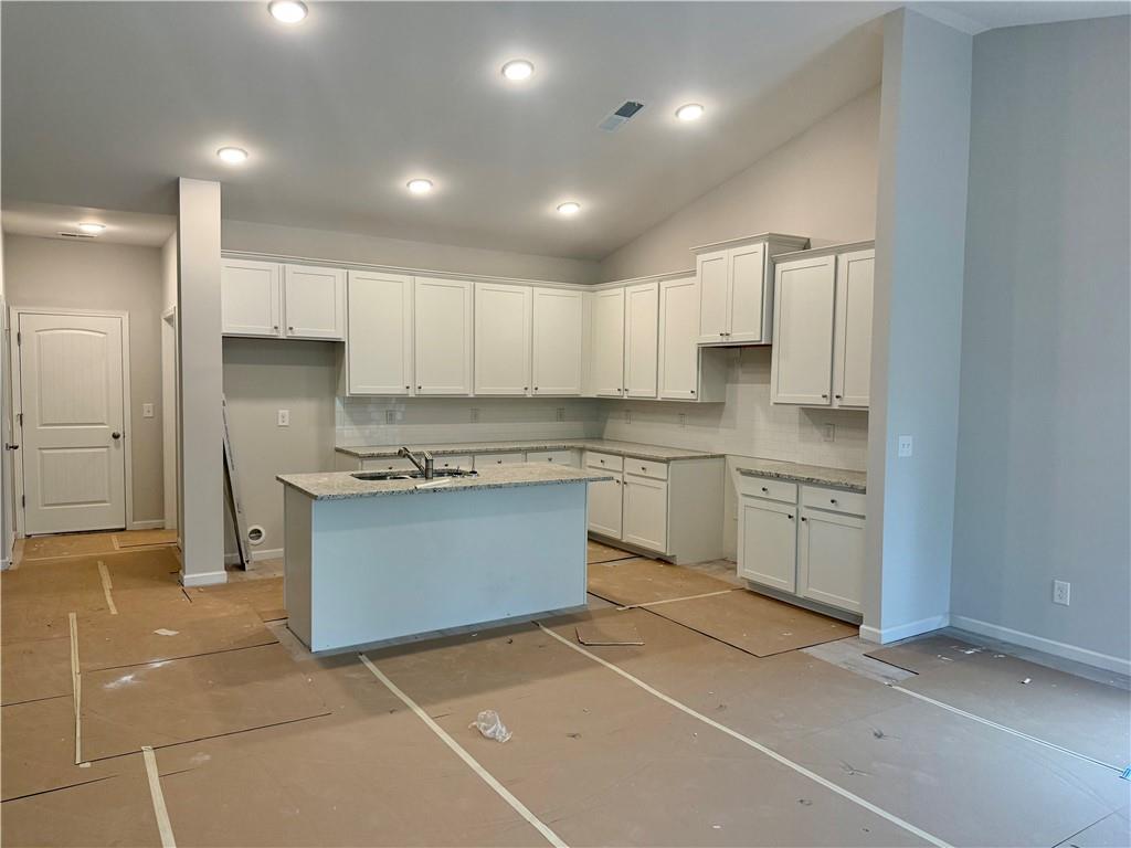 503 Charleston Place Villa Rica, GA 30180 - Photo 8 of 14 a kitchen with stainless steel appliances granite countertop a sink a stove a refrigerator and cabinets