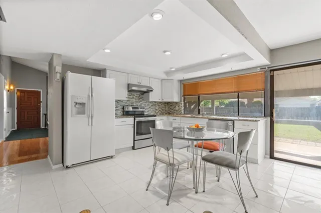 a kitchen with a table and chairs