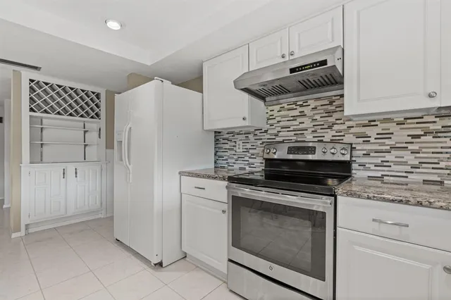 a kitchen with cabinets and steel stainless steel appliances