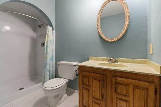 a bathroom with a sink a toilet and a mirror