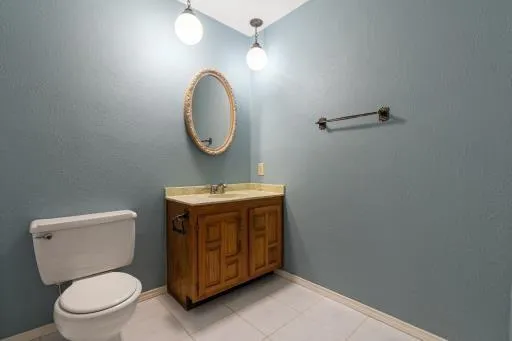 a bathroom with a toilet a sink and mirror