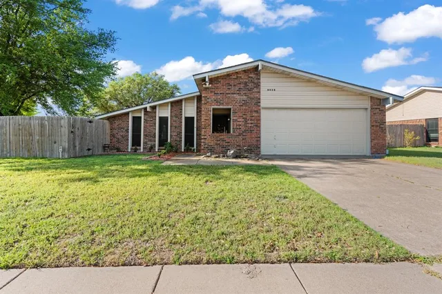 a view of a backyard of the house