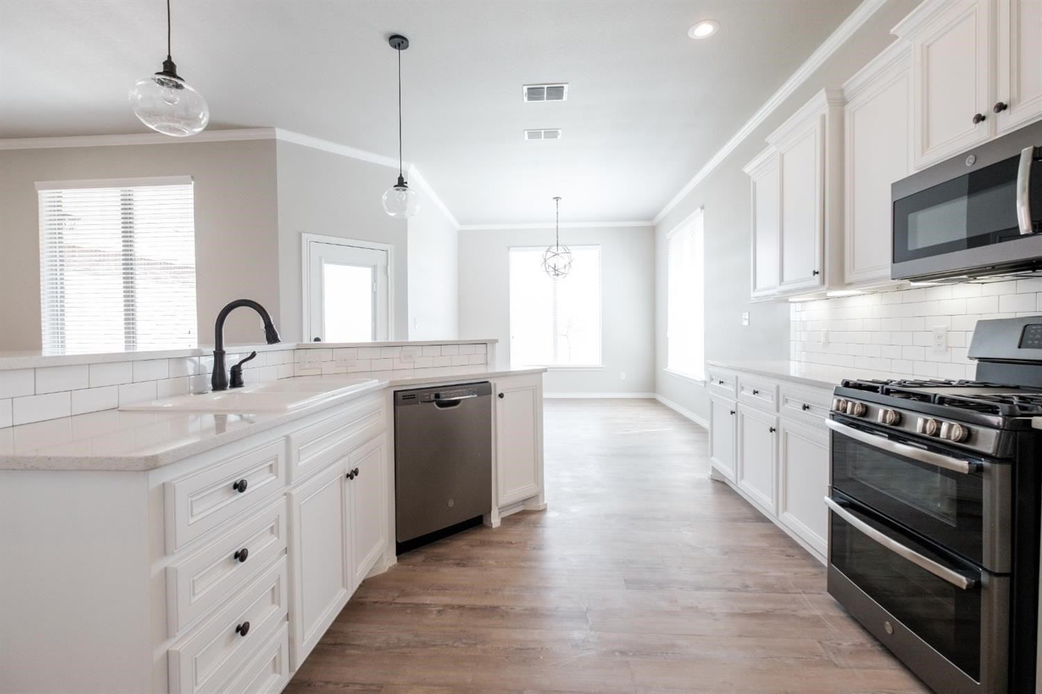 9609 Hyden Avenue Lubbock, TX 79424 - Photo 13 of 29 a kitchen with stainless steel appliances a sink stove and cabinets