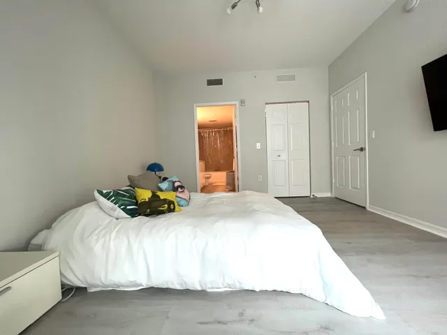 a bedroom with a bed and flat screen tv