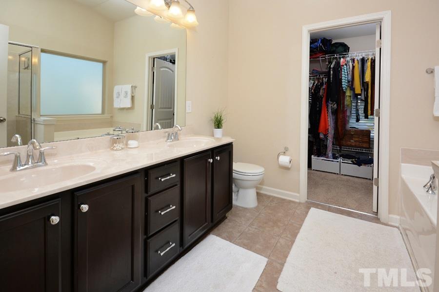 1003 Lakeview Road Durham, NC 27712 - Photo 14 of 25 a spacious bathroom with a double vanity sink toilet and shower