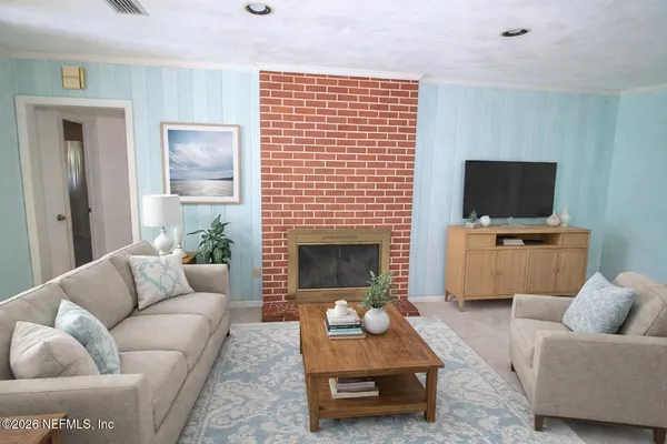 a living room with furniture and a fireplace