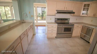a kitchen with stainless steel appliances granite countertop a stove and a sink