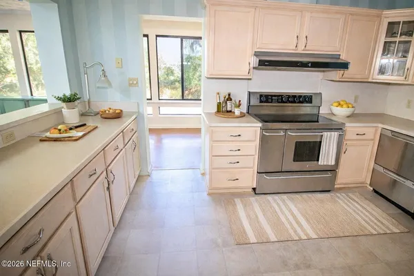 a kitchen with a stove oven and a window