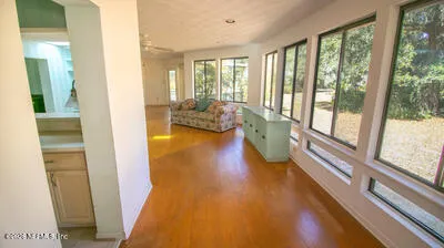 a view of an entryway with wooden floor and a livingroom