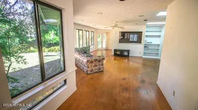 a living room with furniture and large windows