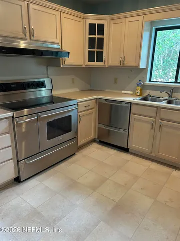 a kitchen with stainless steel appliances granite countertop a sink and a stove