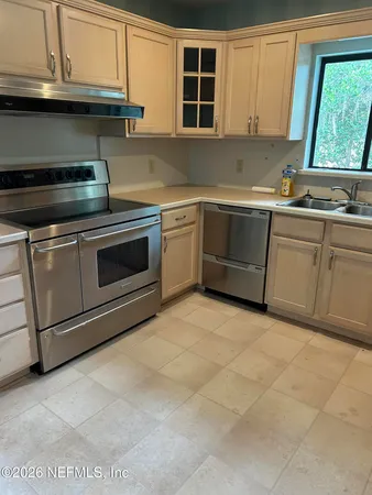 a kitchen with stainless steel appliances granite countertop a sink and a stove