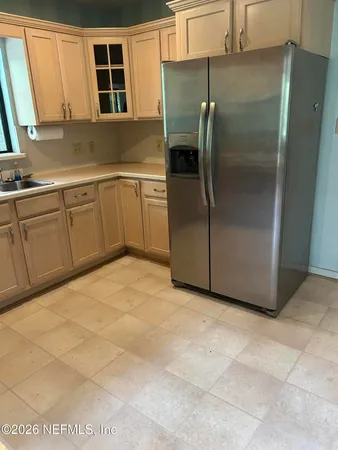 a kitchen with stainless steel appliances a refrigerator sink and cabinets