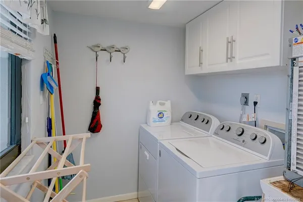 a white refrigerator freezer and a wooden floor