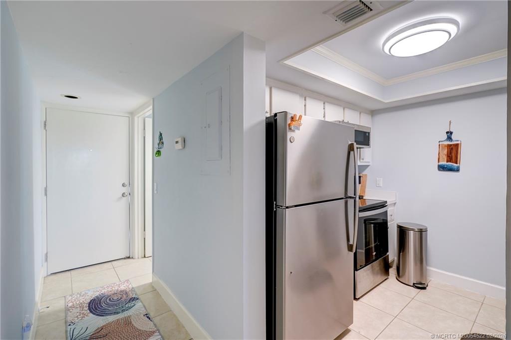 40 Northeast Plantation Road, Unit 309 Jensen Beach, FL 34957 - Photo 12 of 44 a white refrigerator freezer and a wooden floor