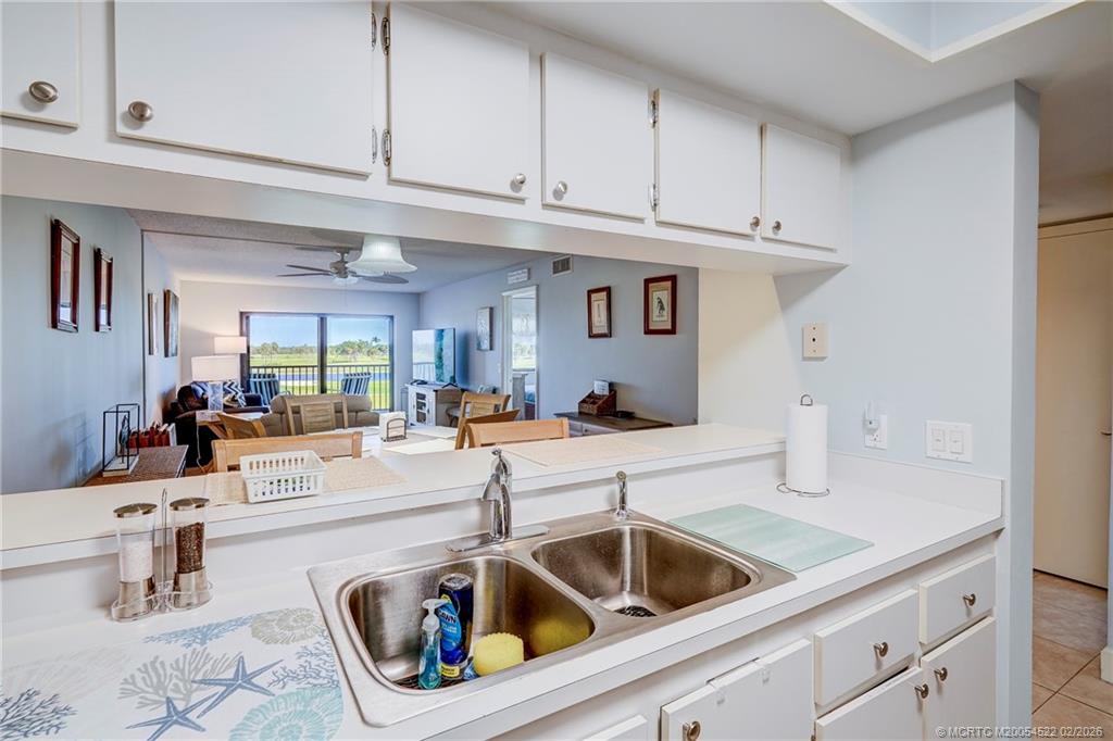 40 Northeast Plantation Road, Unit 309 Jensen Beach, FL 34957 - Photo 15 of 44 a kitchen with a sink and cabinets