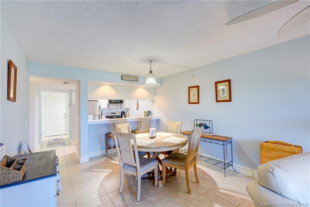 40 Northeast Plantation Road, Unit 309 Jensen Beach, FL 34957 - Photo 20 of 44 a dining room with a table and chairs